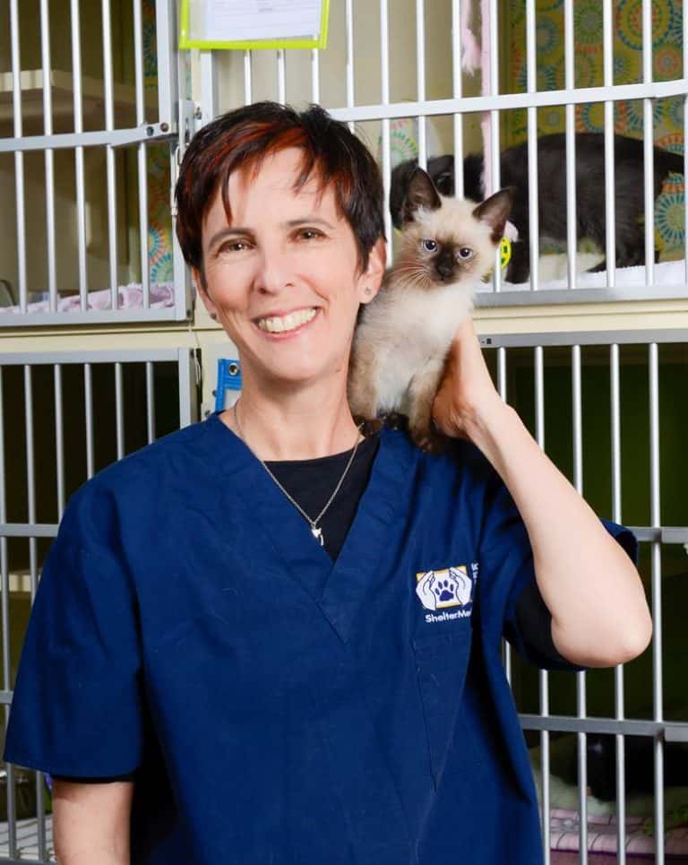 A woman holding a cat.